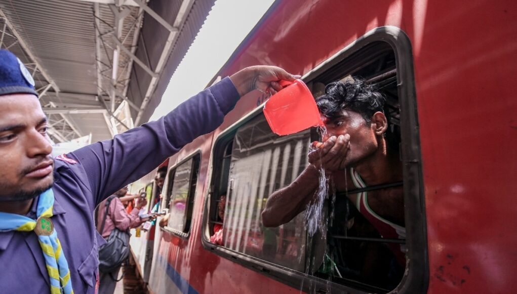 a-volunteer-serves-drinking-water-to-passengers-boarding-a-train-amid-hot-weather-conditions-at-the-272347529-16x9_0.jpg