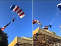 US skydiver carrying huge flag crashes into rodeo tent, walks away unhurt