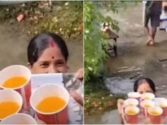 Assam woman serves juice to relief workers while standing in waist-deep floodwater