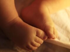 Police officer charged over assault on newborn child