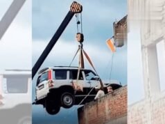 Bengal gentleman parks SUV on balcony with crane while traveling abroad.