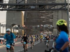 Cyclists shut down iconic bridge for mental health ride