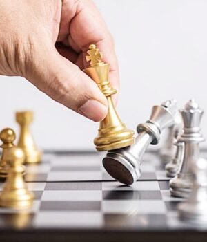pngtree-golden-king-chess-piece-eliminating-team-of-silver-chess-pieces-held-by-mans-hand-photo-image_32117820.jpg